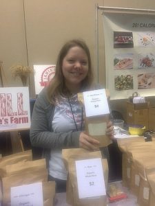 A Mill at Janie's Farm helper displays flour options at Chicago Good Food Expo. Jacobs photo