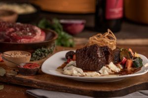 Red-wine braised short ribs with oven-roasted vegetables, mashed potatoes, grainy dijon mustard butter and crispy onion strings. (Cooper's Hawk photo)