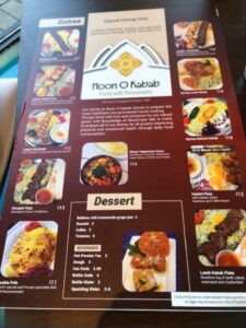 Cheerful menus are on the front counter of Noon O Kabab in Highwood so folks order and pay before they sit. (J Jacobs photo)